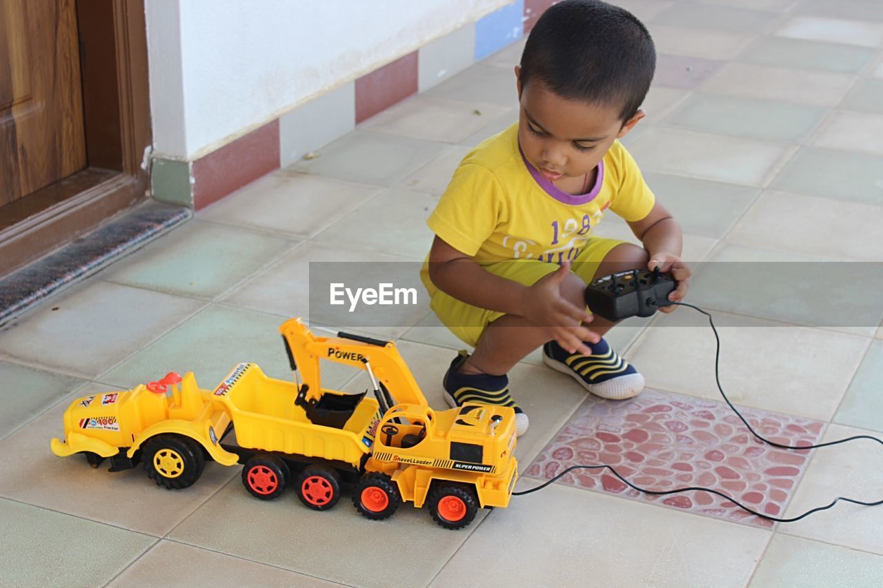 Boy playing with toy car at home