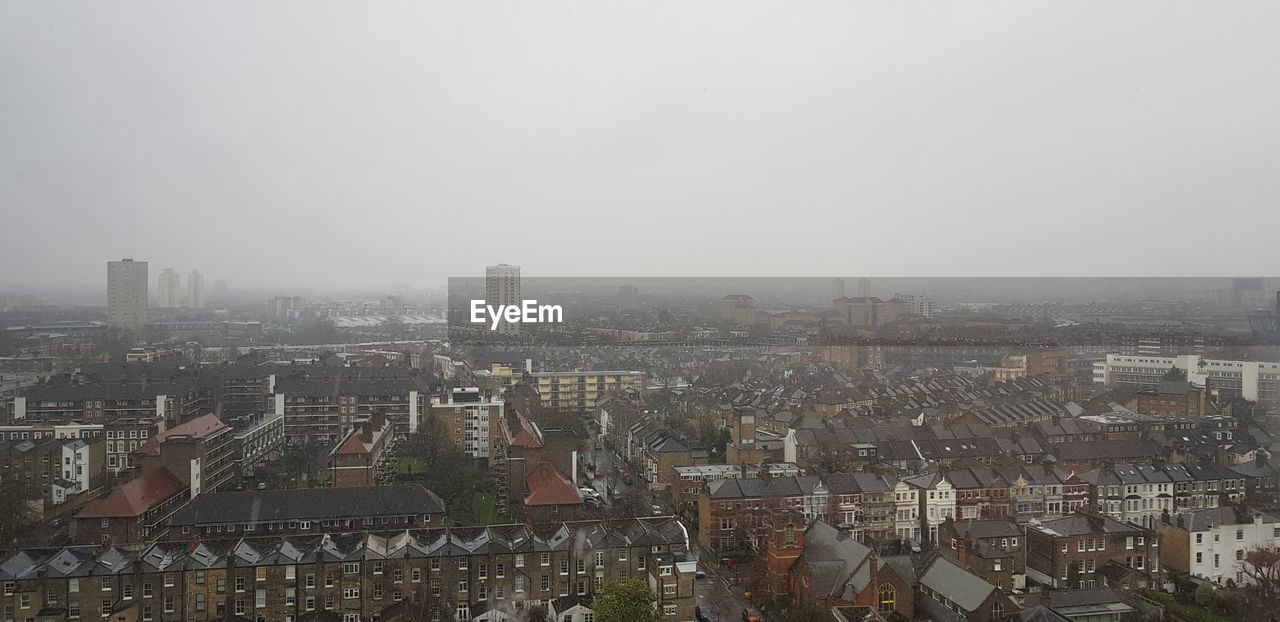 AERIAL VIEW OF CITYSCAPE AGAINST SKY