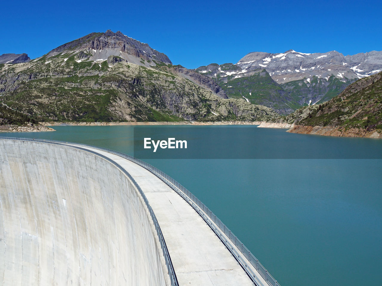 High angle view of dam and lake against mountains
