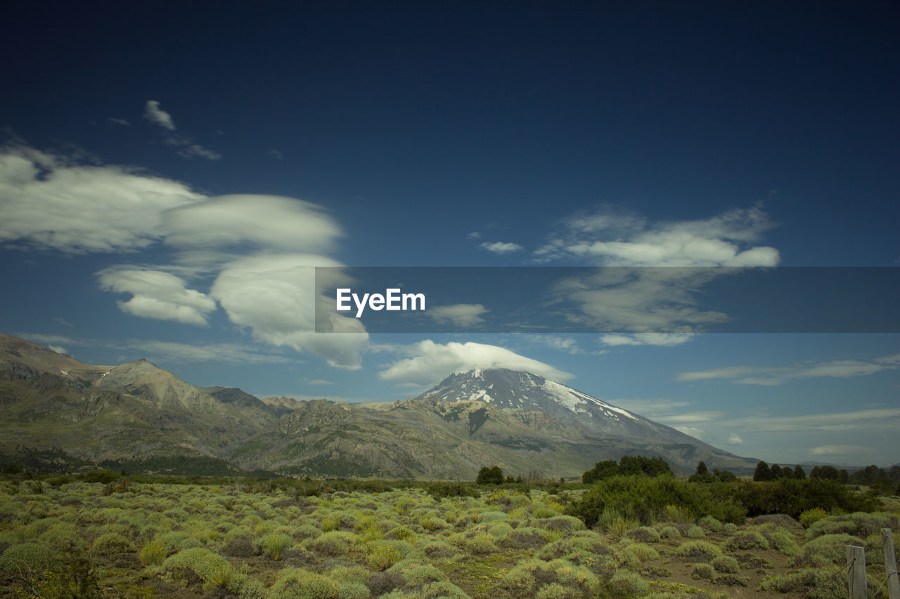 Scenic view of mountains against cloudy sky