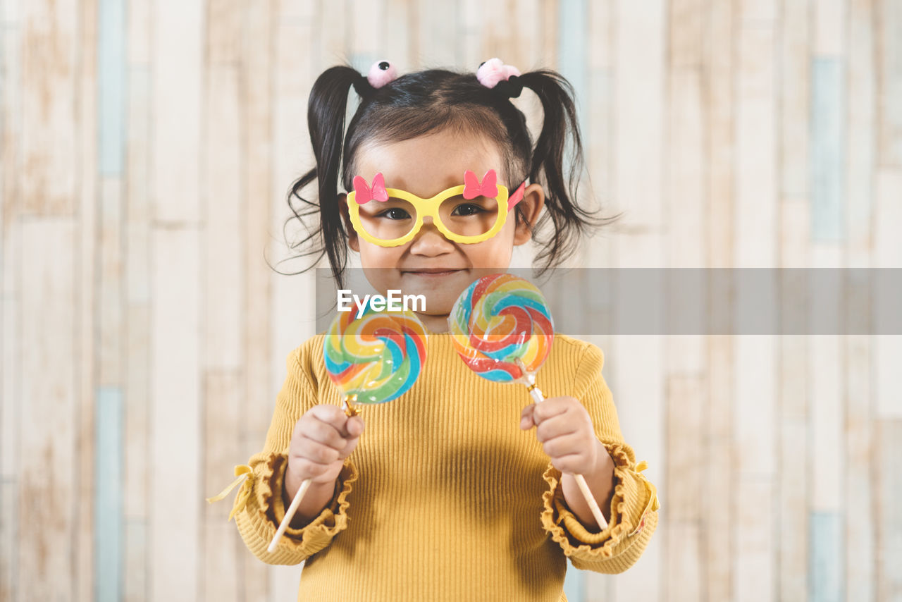 Portrait of girl holding lollipop