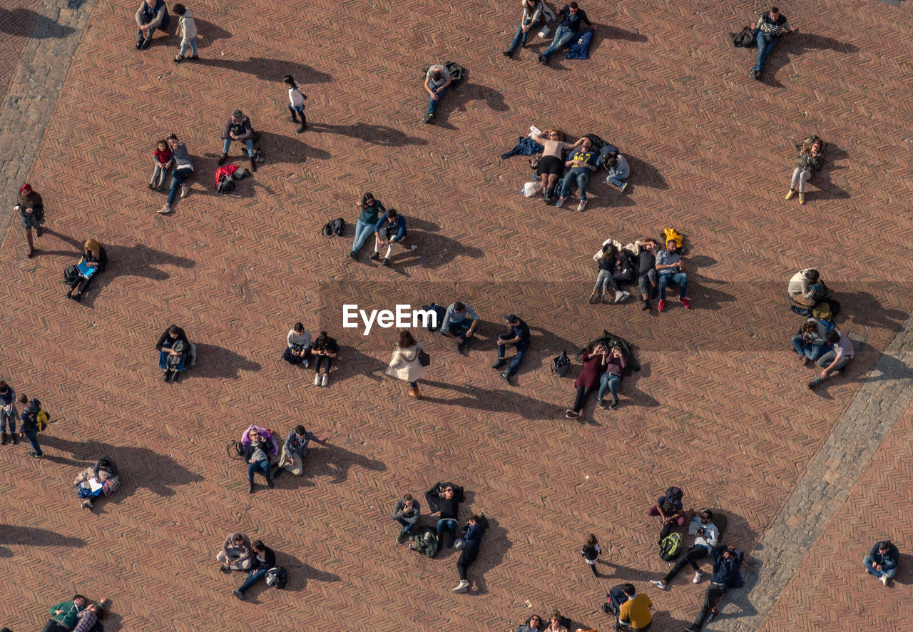 High angle view of people on street during sunny day