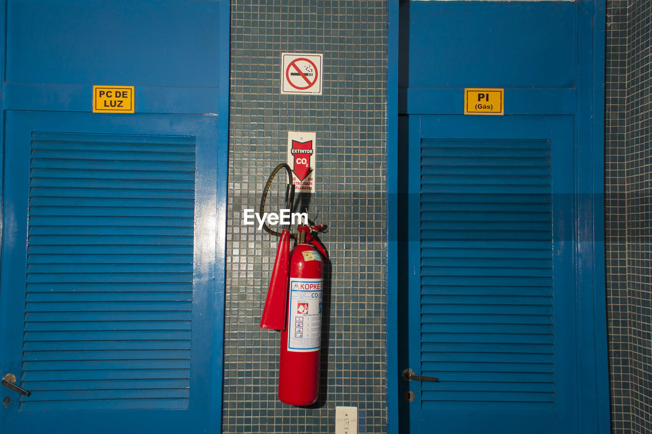 sign, communication, fire extinguisher, no people, blue, security, protection, emergency equipment, red, text, architecture, accidents and disasters, entrance, technology, closed, door, warning sign