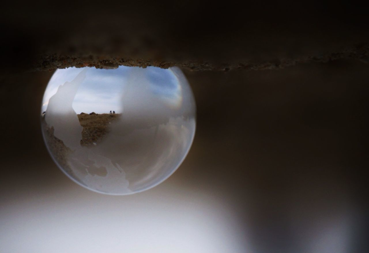 Reflection of landscape on bubble