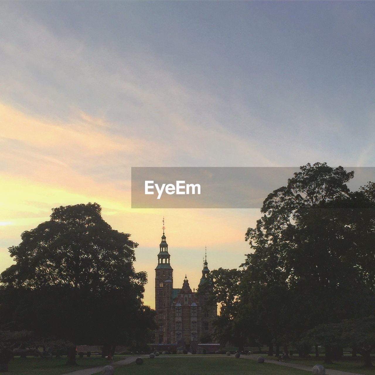 Scenic view of rosenborg castle gardens against sky during sunset