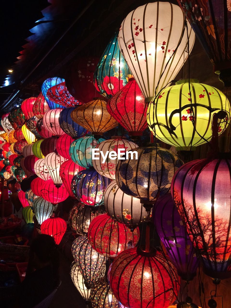 Colorful illuminated lanterns hanging at night