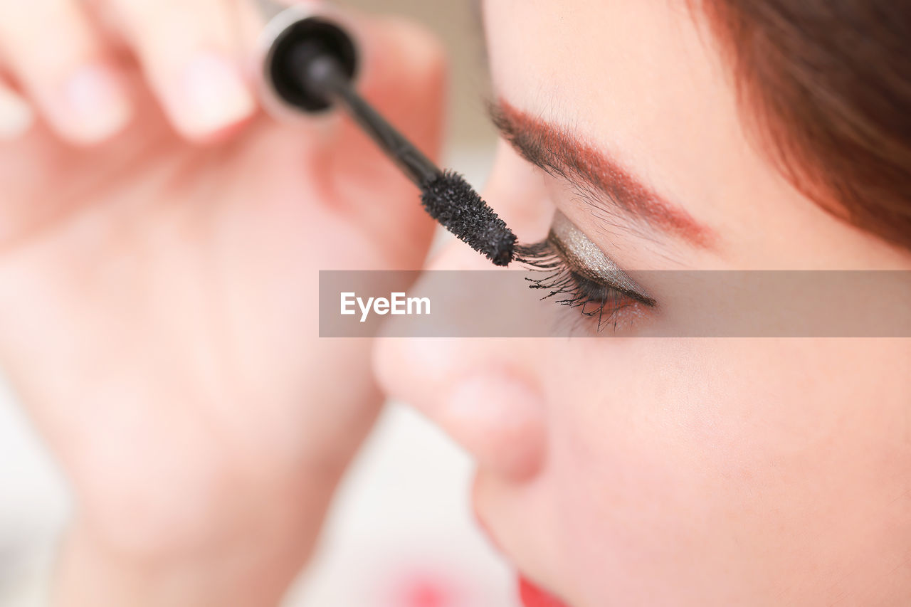 Close-up of woman applying mascara