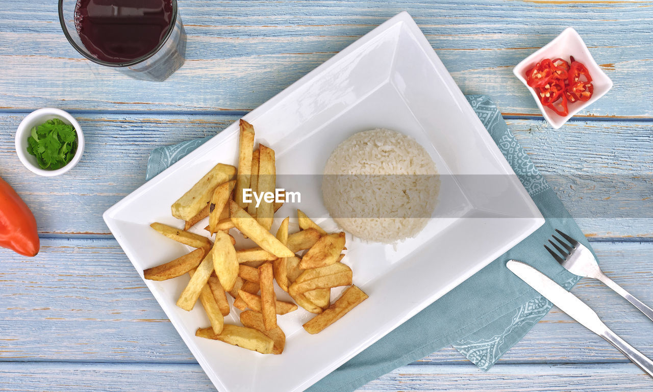 Rice and fries sides, top view food plate, chilli and chicha morada