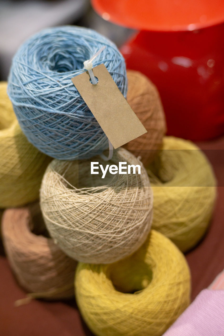 High angle view of threads stacked indoors