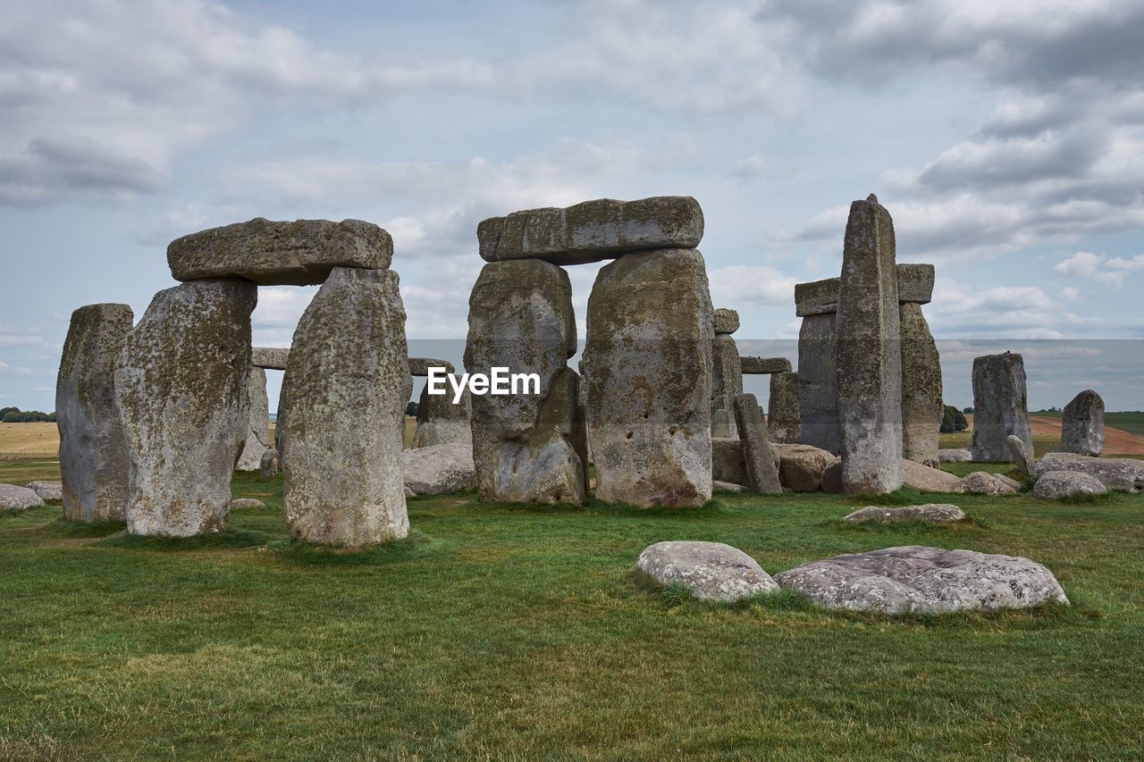 Stone structure on field against sky