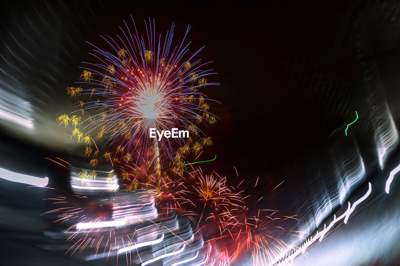 LOW ANGLE VIEW OF FIREWORK DISPLAY