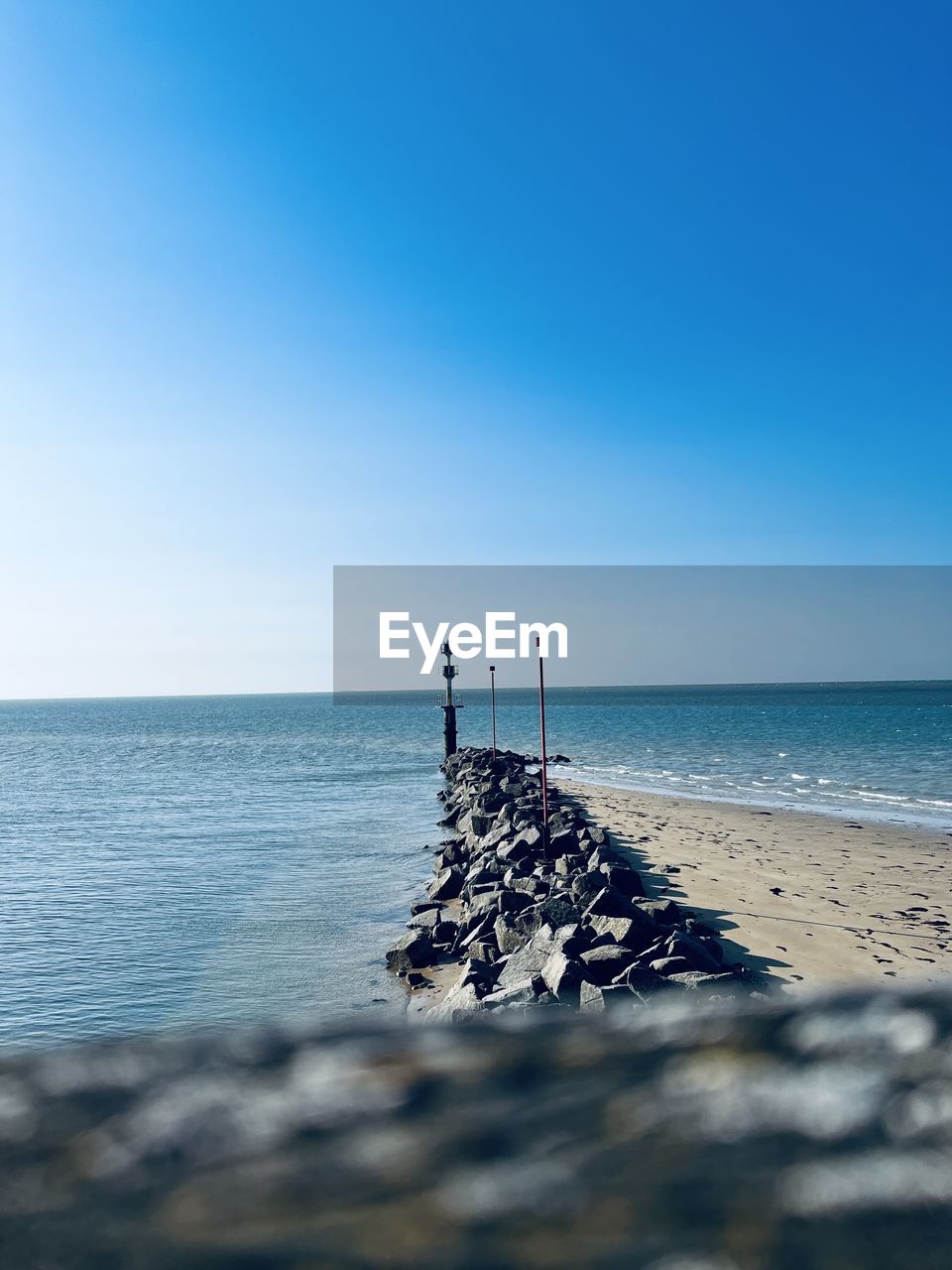 sea, water, sky, horizon over water, beach, horizon, land, ocean, nature, shore, scenics - nature, beauty in nature, blue, body of water, clear sky, tranquility, coast, wave, tranquil scene, day, copy space, tower, no people, sunlight, breakwater, outdoors, idyllic, sand, sunny, travel destinations, holiday, non-urban scene, travel, vacation, seascape, architecture, trip, bay, summer, coastline