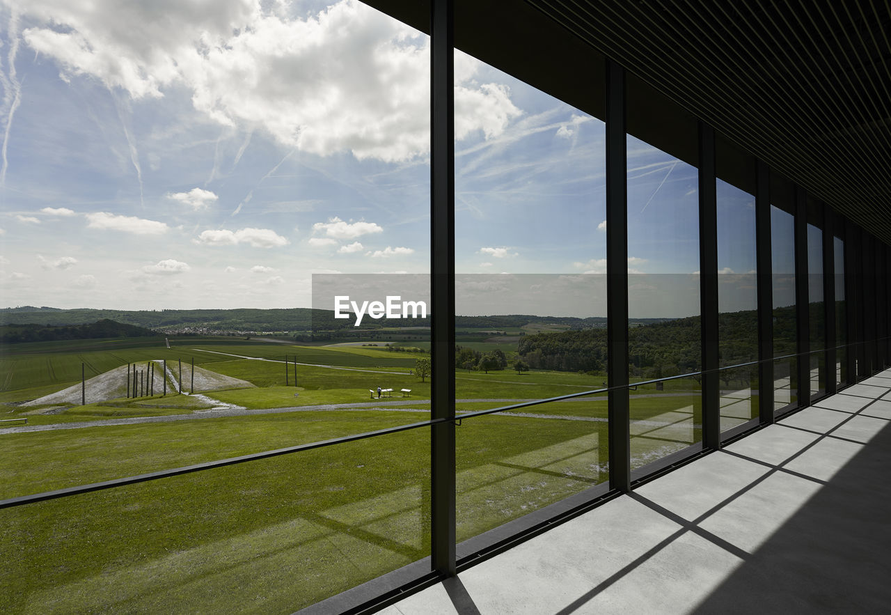 Scenic view of field seen through window