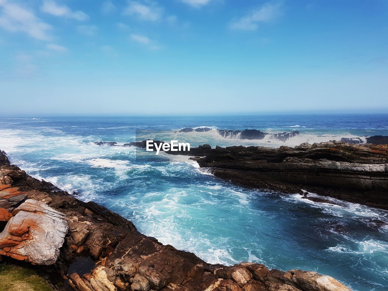 Scenic view of sea against blue sky