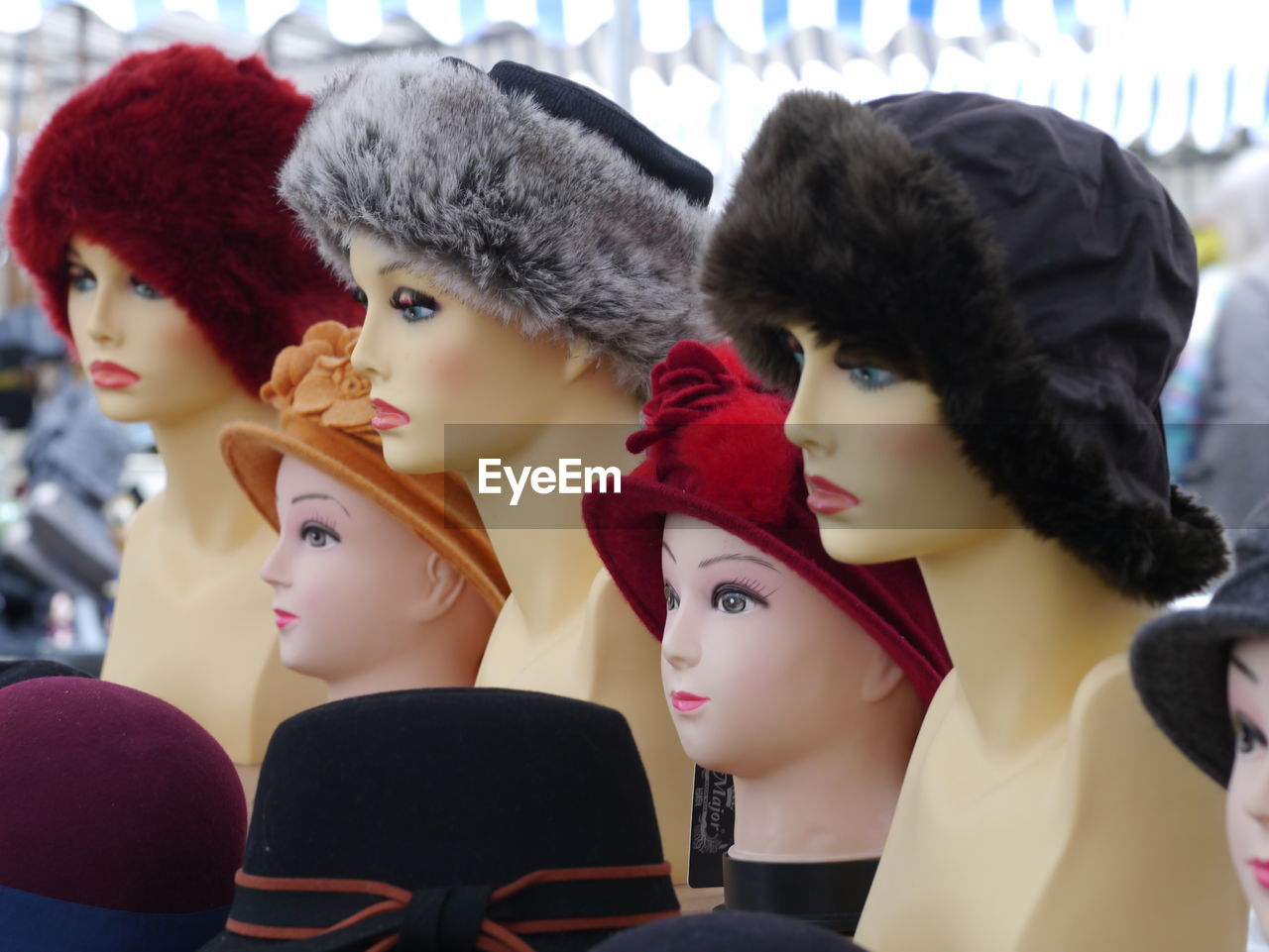 Various hats on mannequin head at store