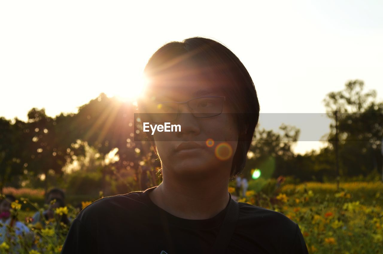 Portrait of young man against sky during sunset