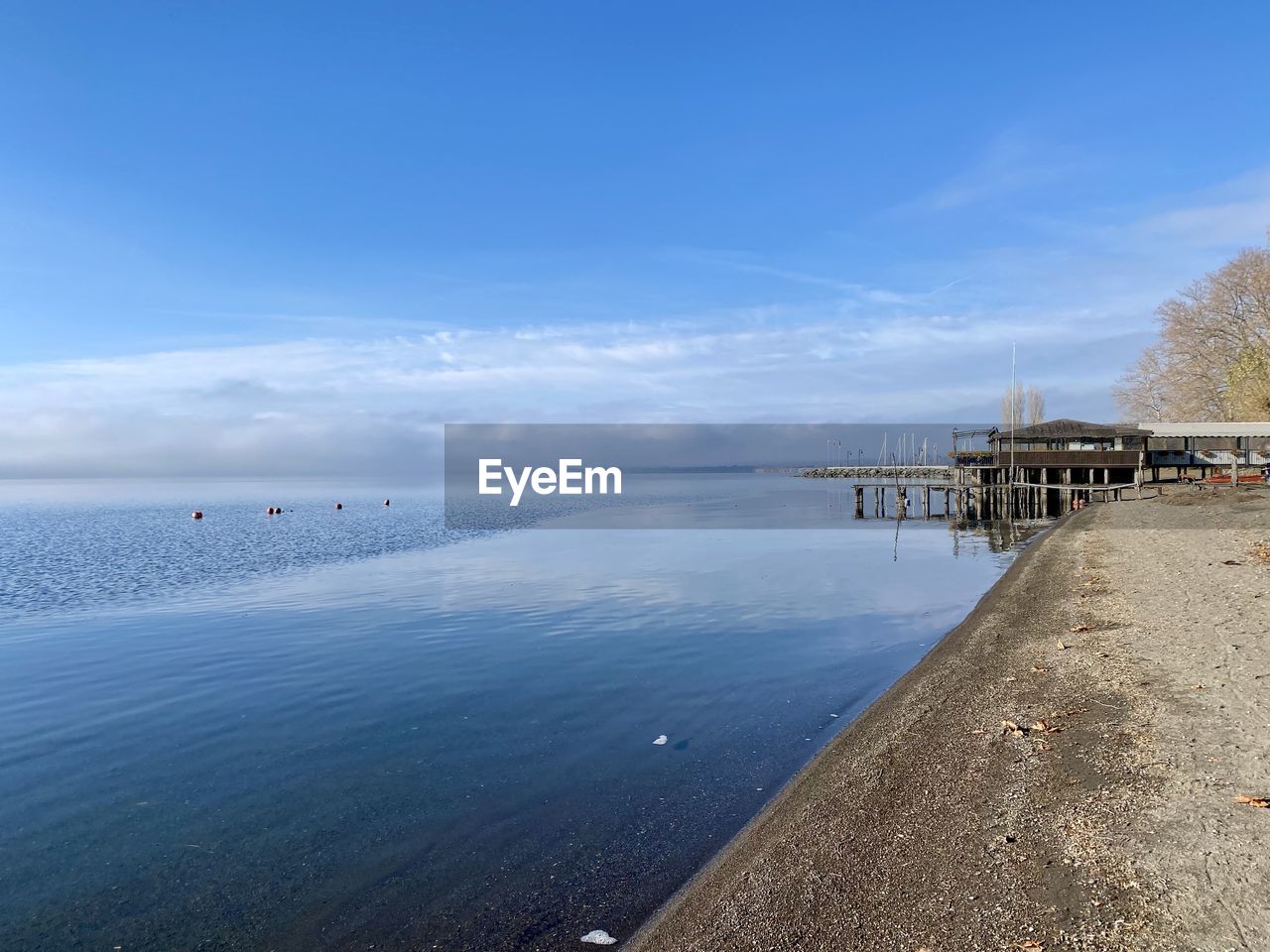 water, sky, shore, sea, body of water, horizon, coast, beach, nature, ocean, scenics - nature, land, beauty in nature, cloud, tranquility, blue, tranquil scene, bay, architecture, pier, day, built structure, travel destinations, reflection, outdoors, wave, sand, travel, no people, idyllic, holiday, horizon over water, coastline, non-urban scene, vacation, trip, tourism, building exterior, environment, morning, transportation, jetty, landscape, tree, reservoir, hut, sunlight, nautical vessel