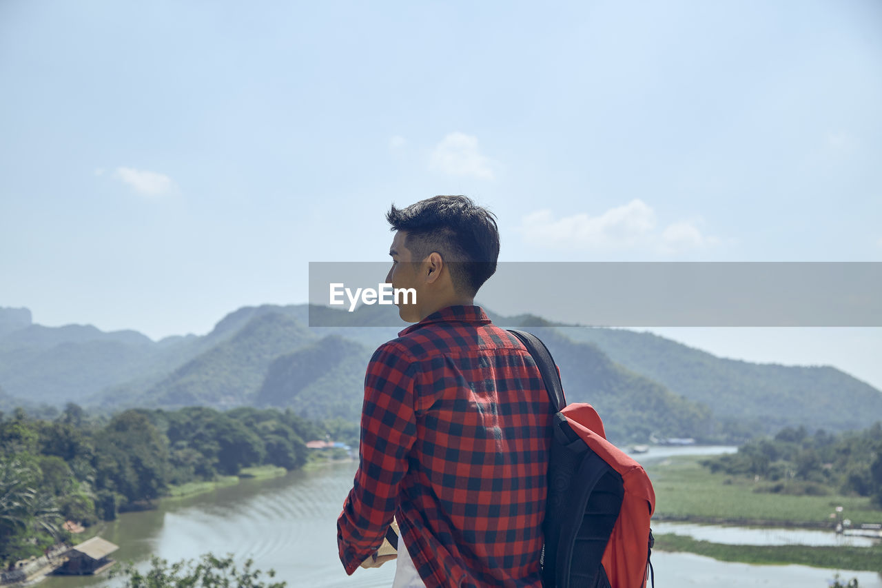 Man standing on mountain against sky