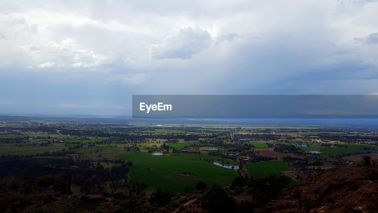 High angle view of field against cloudy sky