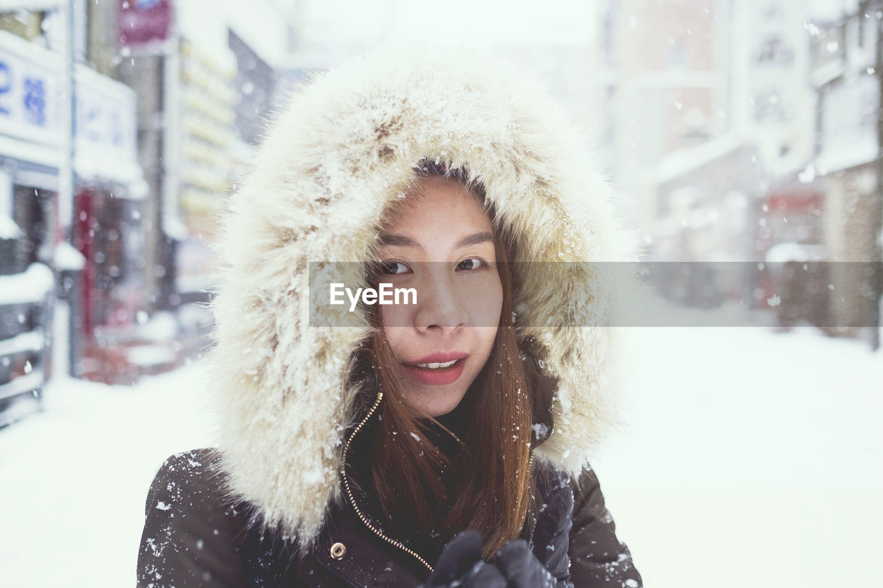 Portrait of young woman in snow