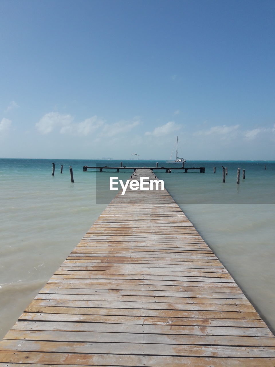 Pier over sea against sky