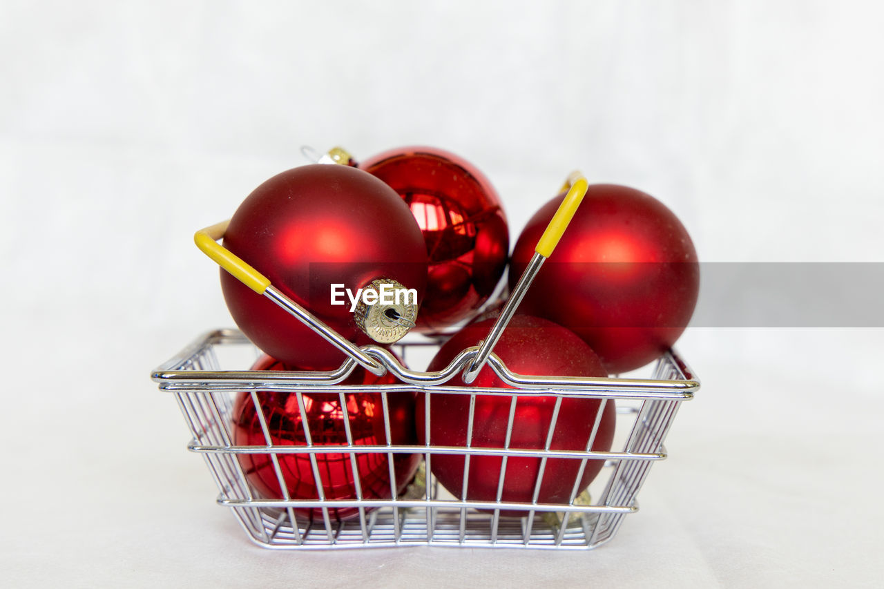 Close-up of red christmas ball in basket 