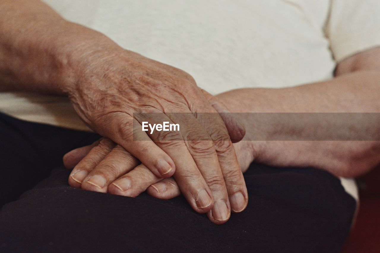 Midsection of senior man with hands clasped