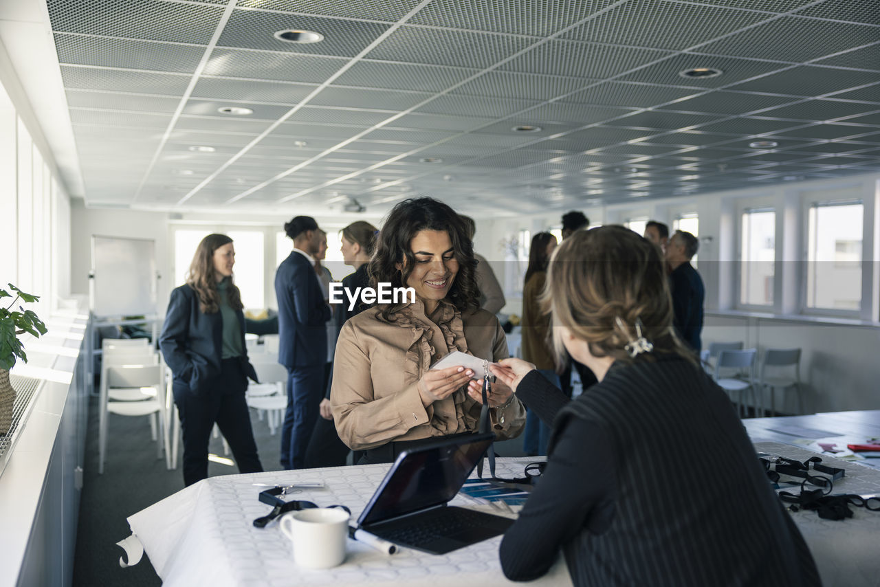 Woman picking up her pass before conference