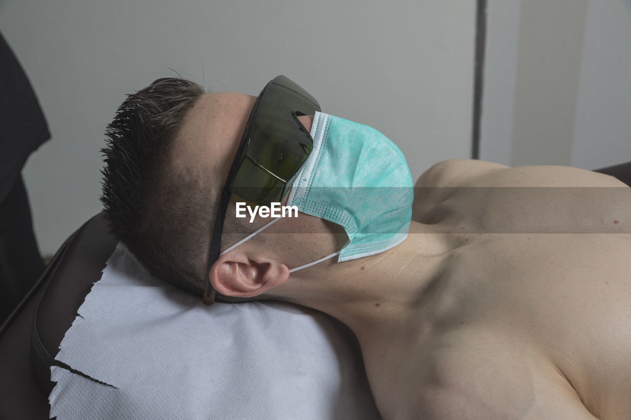 Beautician working with mask and protective screen for the virus covid