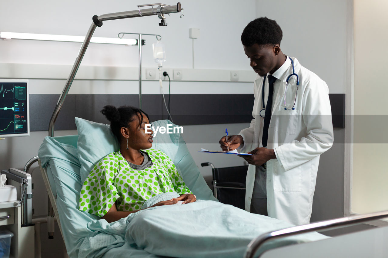 Doctor examining patient in clinic