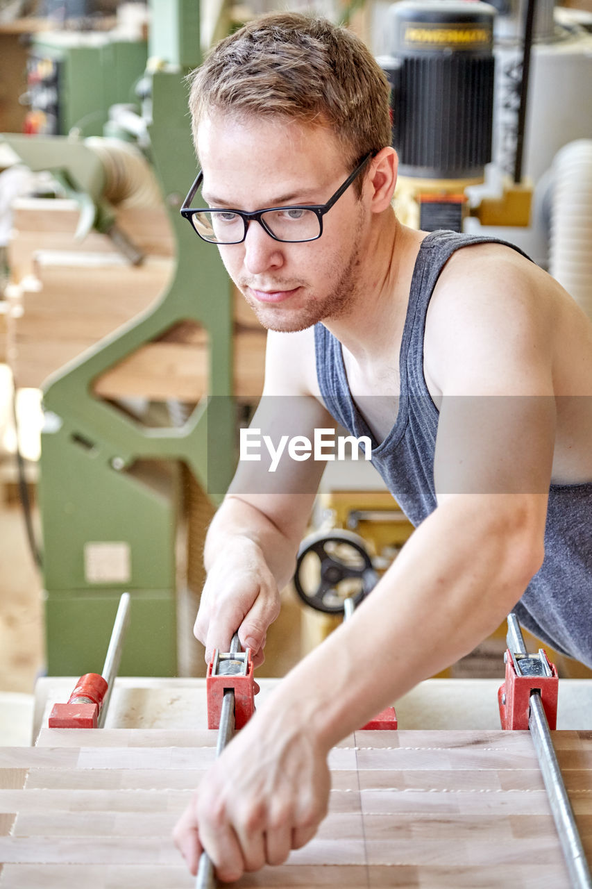 Confident carpenter working in workshop