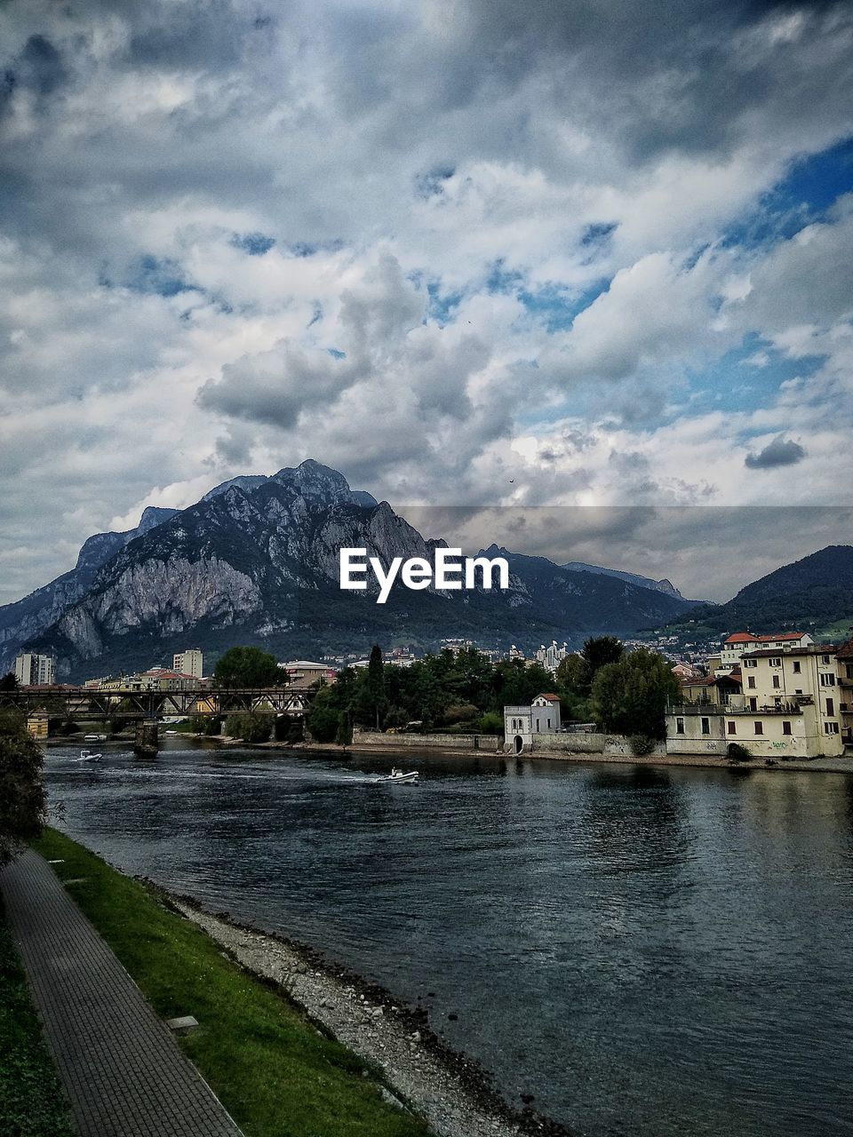 Scenic view of lake by buildings against sky