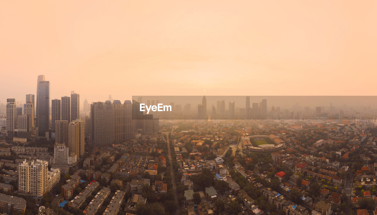 High angle view of modern buildings in city against sky