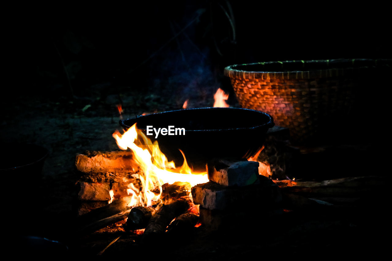 Close-up of container on fire at night