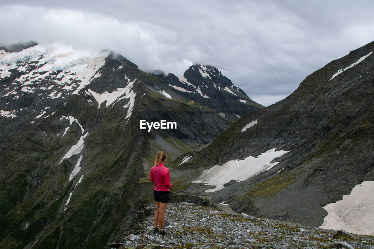 Full length of woman standing on cliff