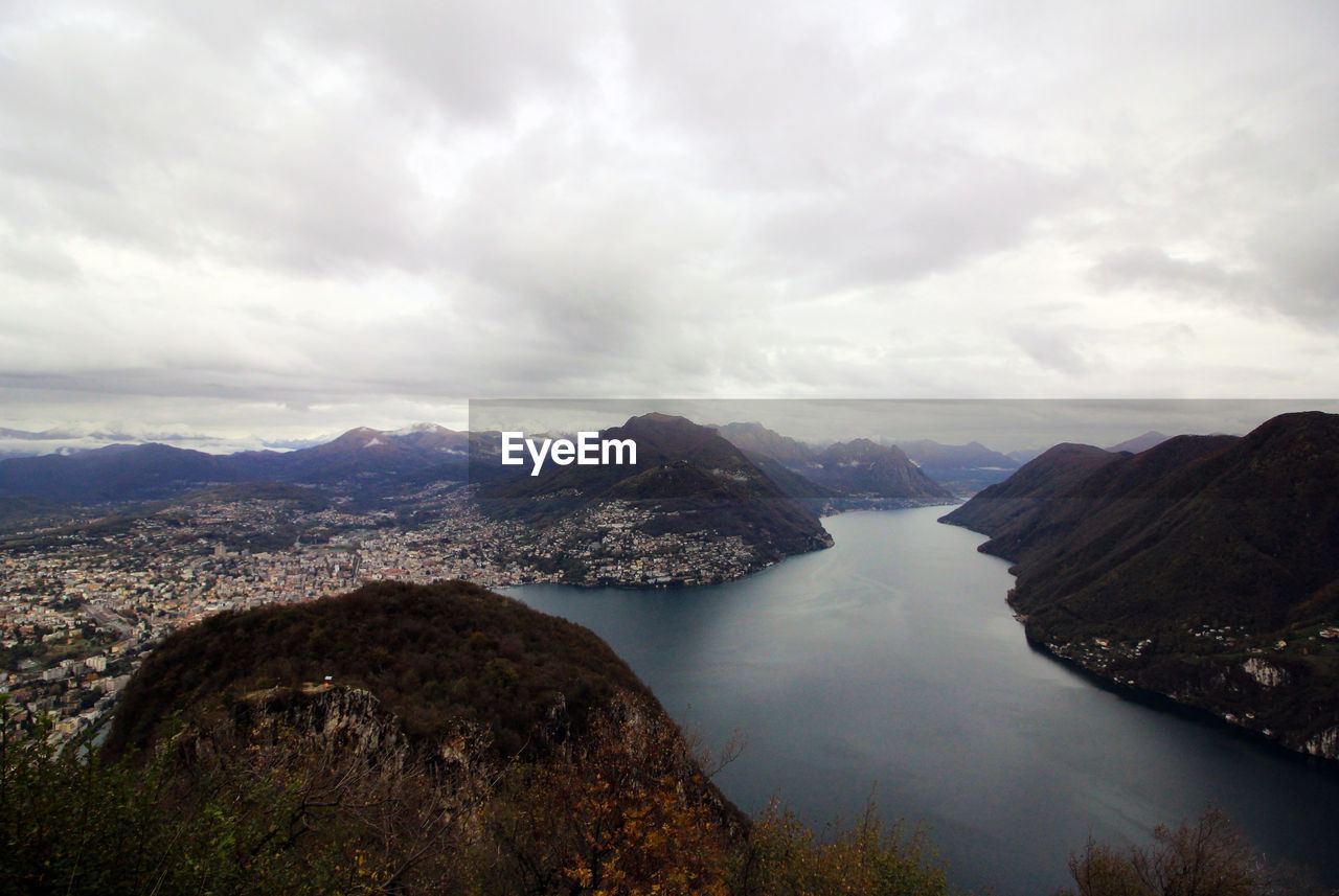 Scenic view of lake and mountains against sky