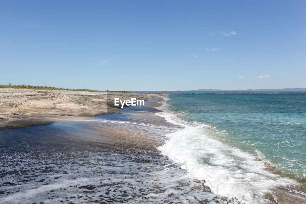 SCENIC VIEW OF BEACH AGAINST BLUE SKY