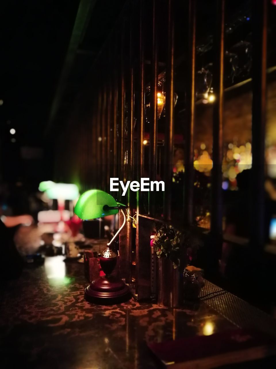 CLOSE-UP OF ILLUMINATED TABLE IN RESTAURANT