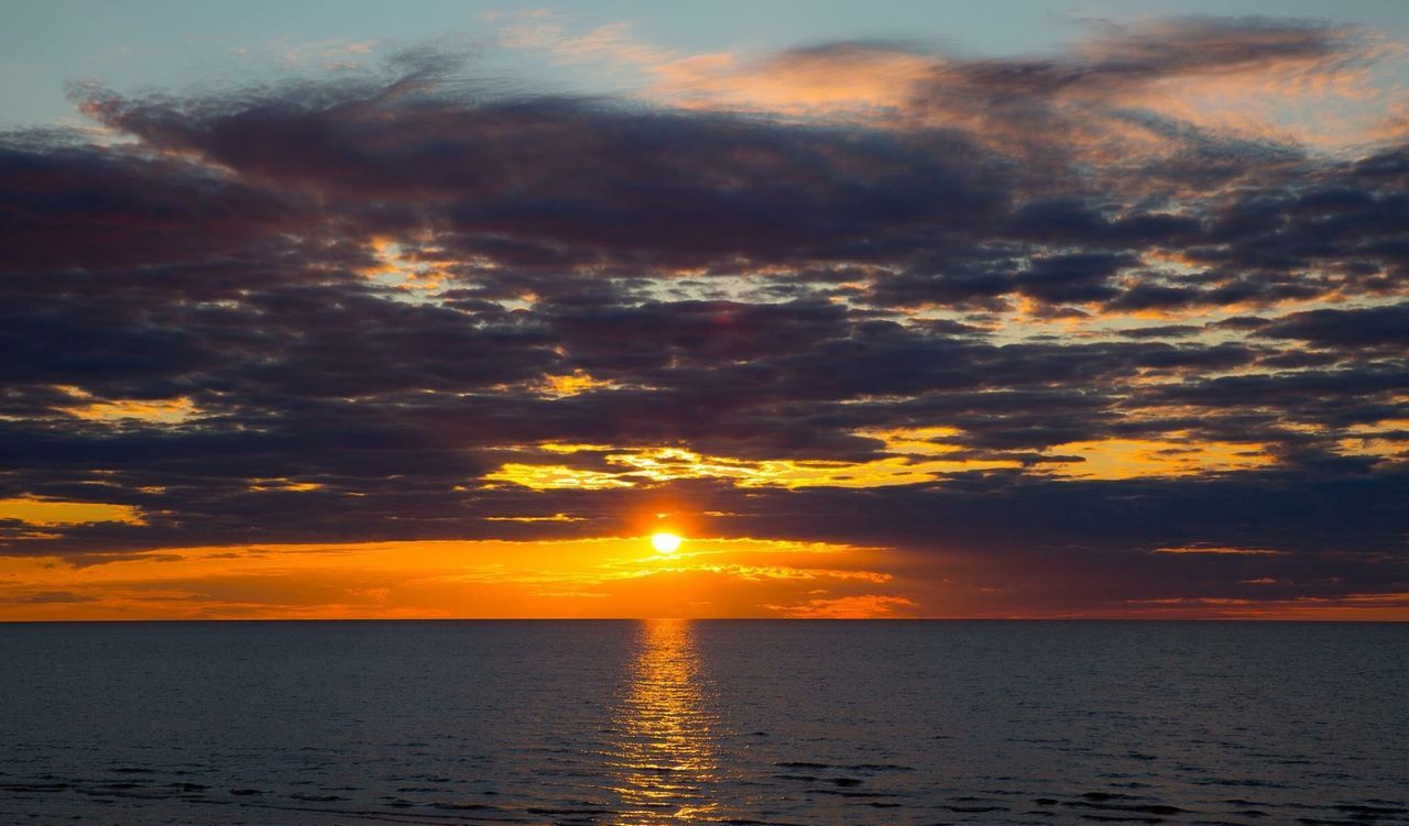 SCENIC VIEW OF SUNSET OVER SEA