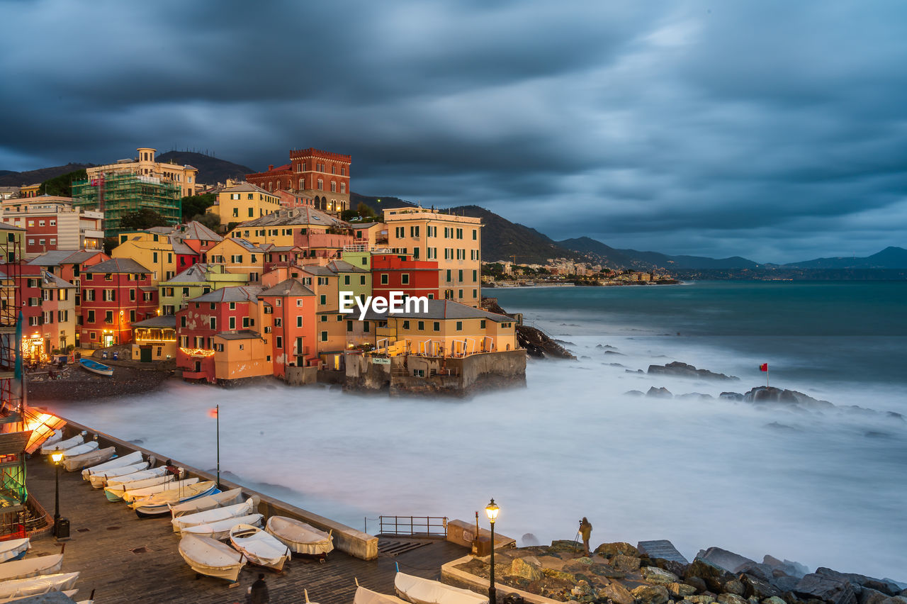 Buildings by sea against sky in city