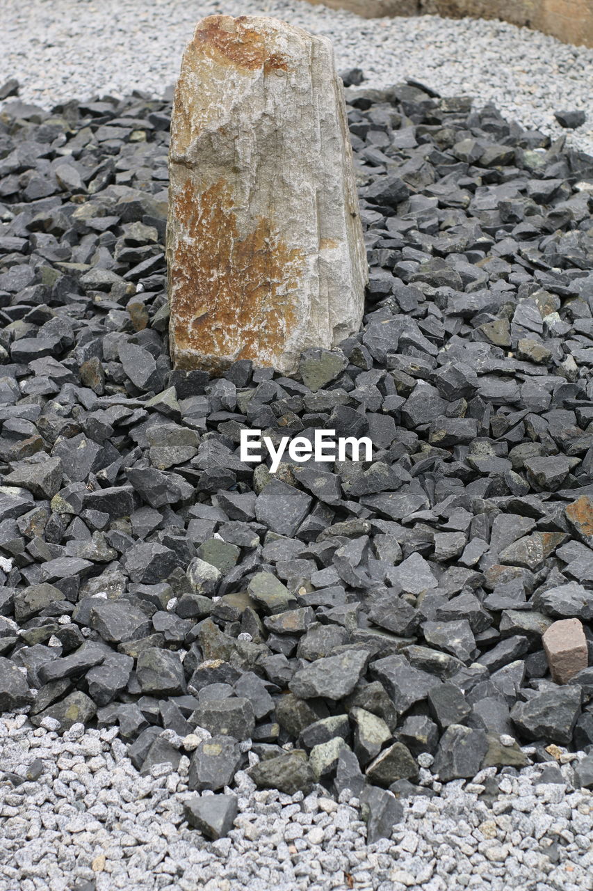 Close-up of stone on sand at beach