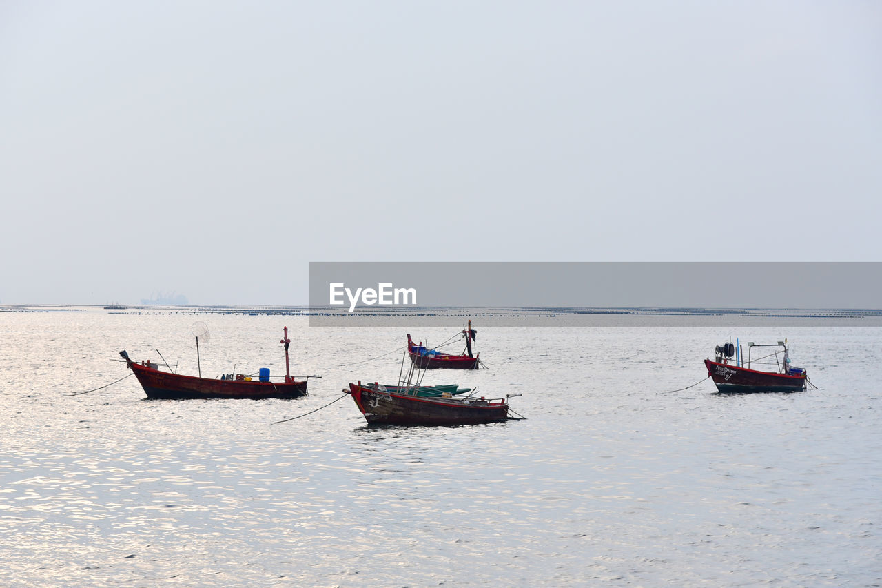water, transportation, nautical vessel, mode of transportation, sea, boat, sky, nature, beach, vehicle, travel, ship, day, shore, watercraft, clear sky, scenics - nature, beauty in nature, copy space, tranquility, land, outdoors, horizon over water, boating, coast, horizon, occupation, tranquil scene, men, non-urban scene, environment, travel destinations, bay