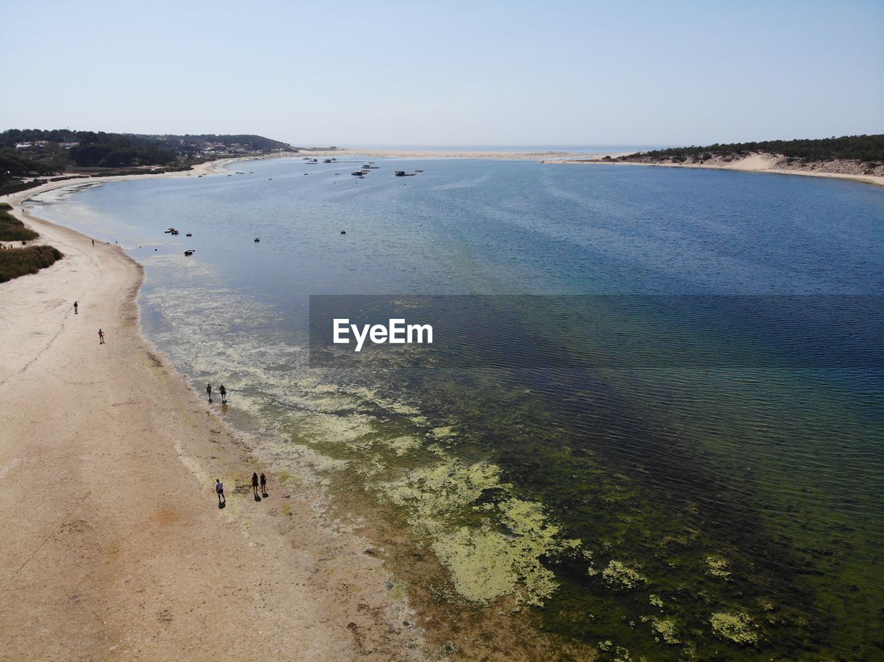 HIGH ANGLE VIEW OF PEOPLE ON BEACH AGAINST SKY