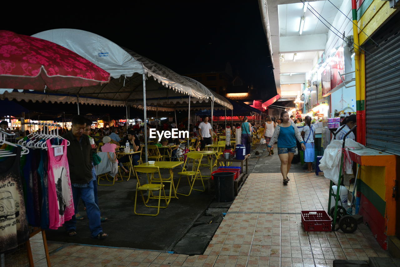 PEOPLE ON MARKET STALL