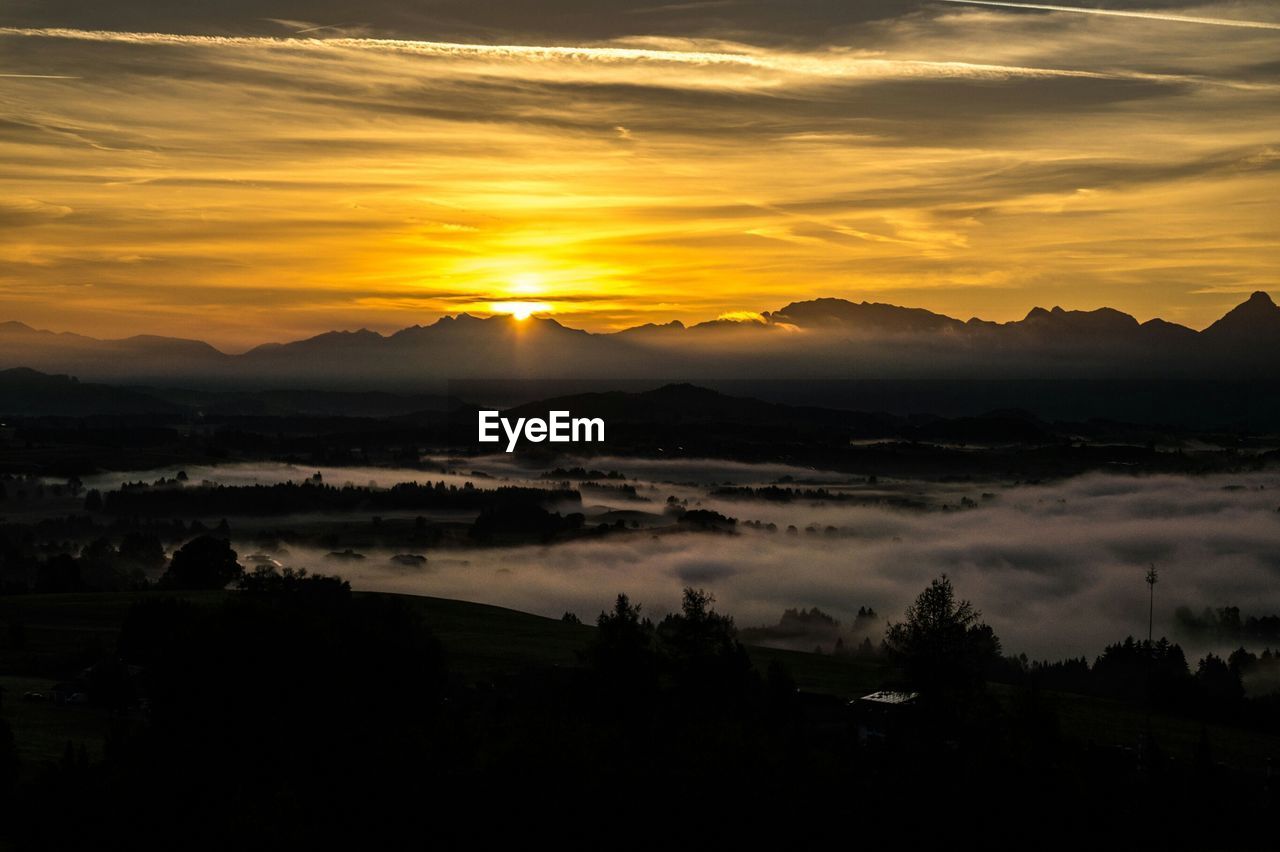 Scenic view of landscape against sky at sunset