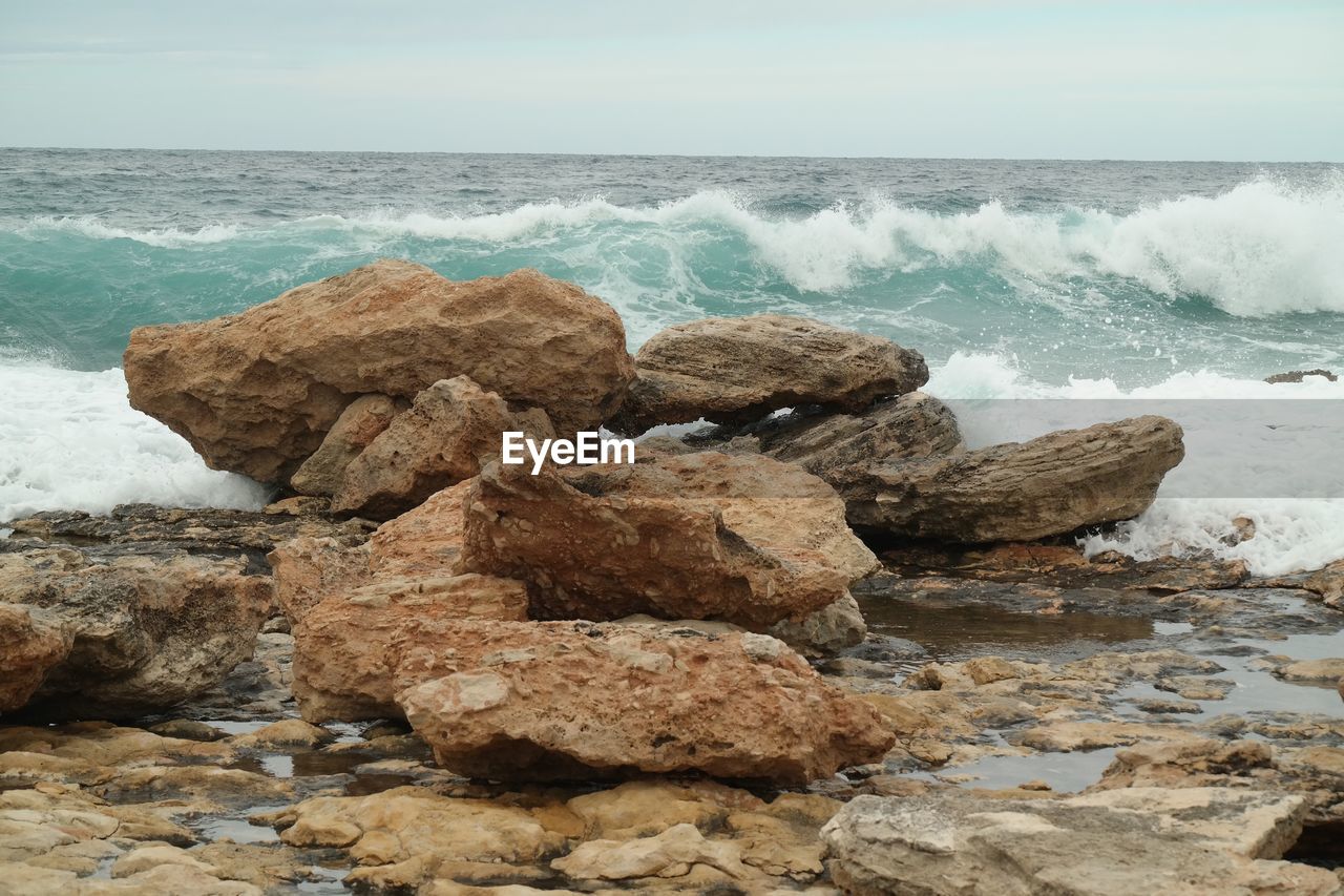 CLOSE-UP OF WAVES ON BEACH