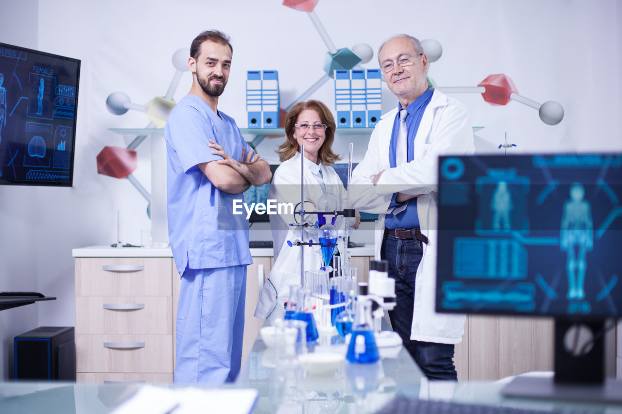 portrait of female doctor giving medicine while standing in laboratory