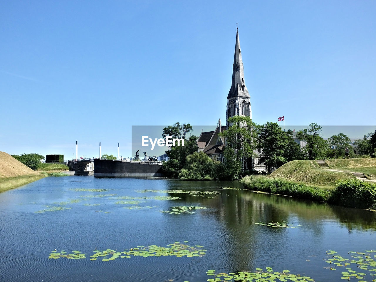 Scenic view of lake against clear blue sky