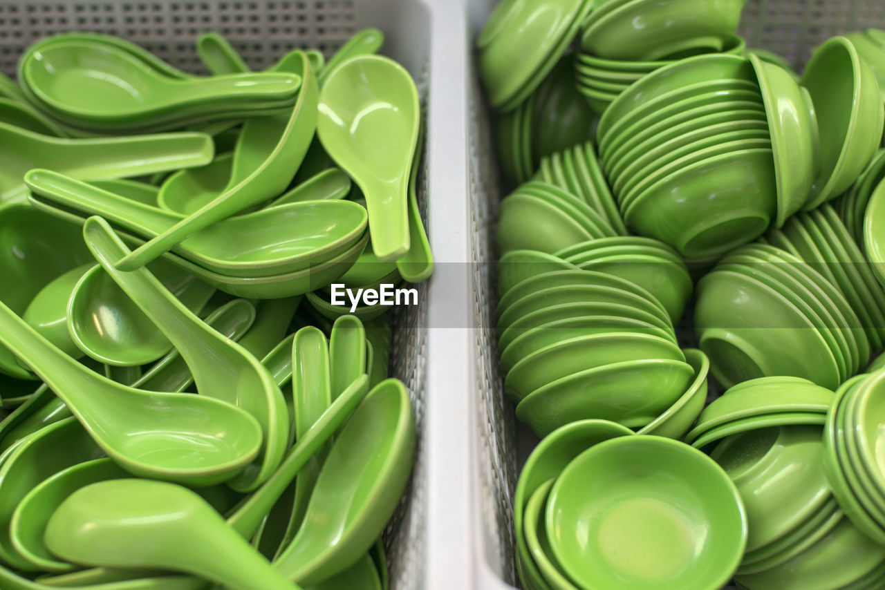 High angle view of green spoons and bowls for sale 