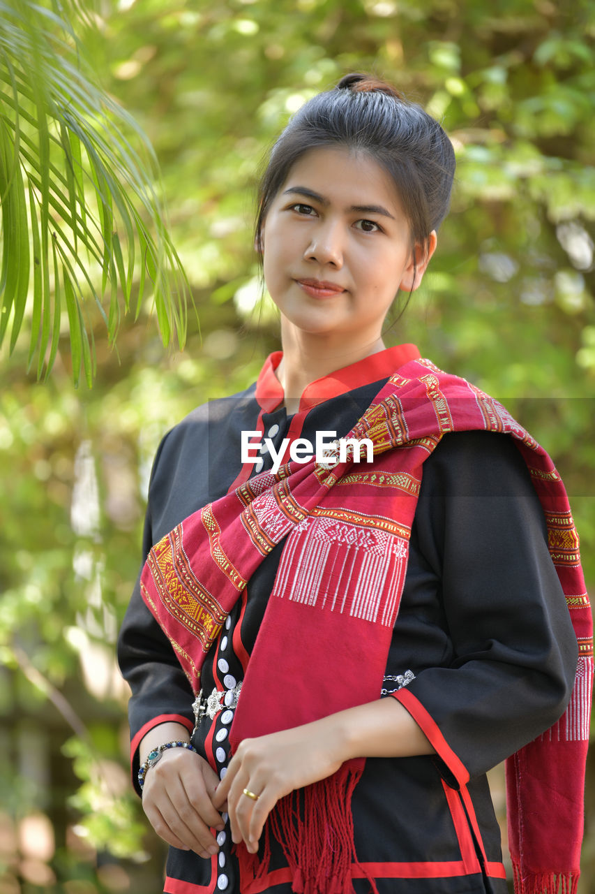 Portrait of beautiful woman in traditional cloths standing outdoors